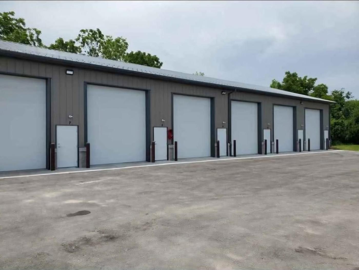 Row of storage units with large white overhead doors and walk-in doors at 20090 W. Lincoln Ave.